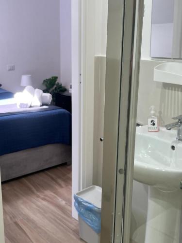 a bathroom with a toilet and a sink and a bed at GIULY SUITES & ROOMS in Naples