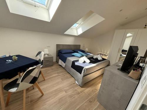 a bedroom with a bed and a dining room with a table at GIULY SUITES & ROOMS in Naples