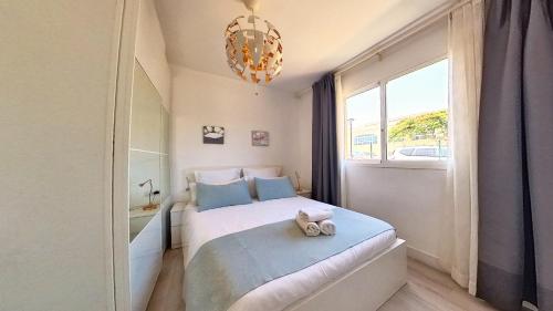 a bedroom with a bed with a teddy bear on it at Residencial Las Dunas, Best Holiday Home Resort On The Island- VV in Corralejo