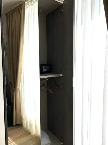 a room with white curtains and a table and a window at GIULY SUITES & ROOMS in Naples