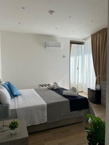 a bedroom with a large bed with blue pillows at GIULY SUITES & ROOMS in Naples