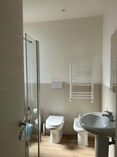a bathroom with a sink and a toilet and a shower at GIULY SUITES & ROOMS in Naples