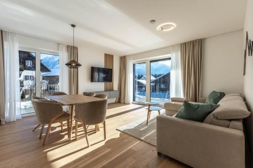 a living room with a couch and a table at Alpine Suite Spot in Bad Mitterndorf