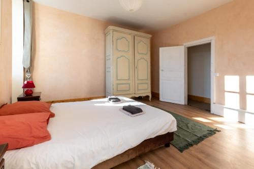 a bedroom with a large bed in a room at La Maison Tonio in Ossun