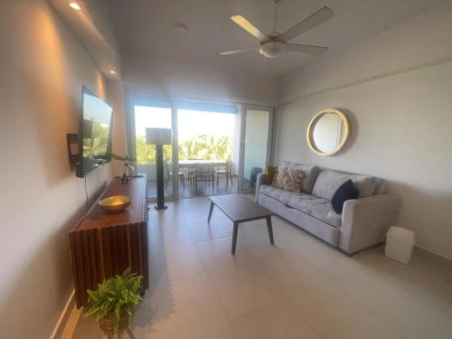 a living room with a couch and a table at Departamento en Nuevo Vallarta in Nuevo Vallarta