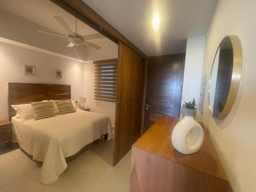 a bedroom with a bed and a ceiling fan at Departamento en Nuevo Vallarta in Nuevo Vallarta 