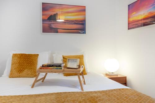 a bedroom with a bed with a table on it at Quinta Pedra Firme in Sintra