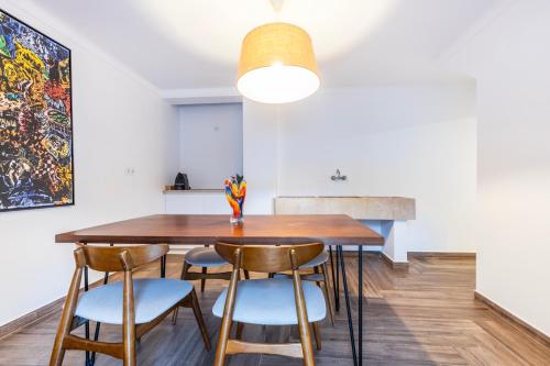 a dining room with a wooden table and chairs at Quinta Pedra Firme in Sintra