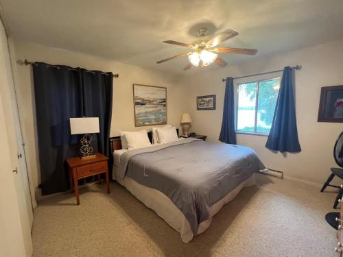 a bedroom with a bed and a ceiling fan at Latitude Adjustment in Traverse City