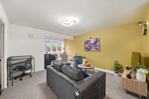 a living room with a couch and a piano at 2-Bed 2 bath flat, Close to tube, Free Parking in London