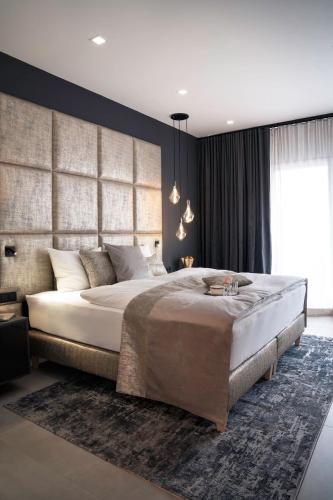 a bedroom with a large bed and a large window at THE NEWSHA SIGNATURE HOME in Mülheim an der Ruhr
