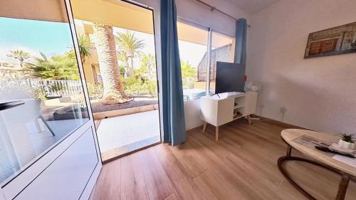 a room with a desk and a computer and a window at Residencial Las Dunas, Best Holiday Home Resort On The Island- VV in Corralejo