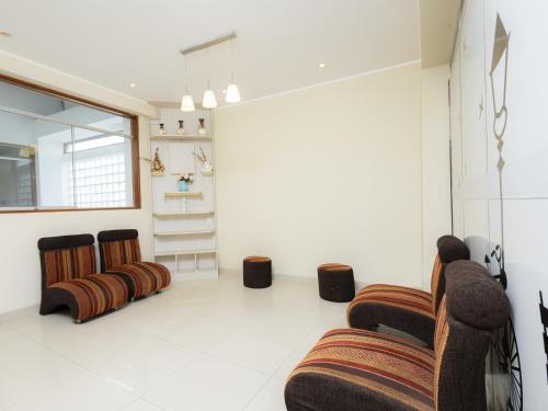 a living room with three chairs and a table at Hotel San Marino Tarapoto in Tarapoto