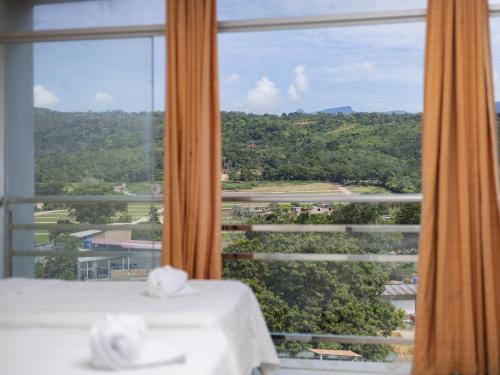 a room with a window with a view at Hotel San Marino Tarapoto in Tarapoto