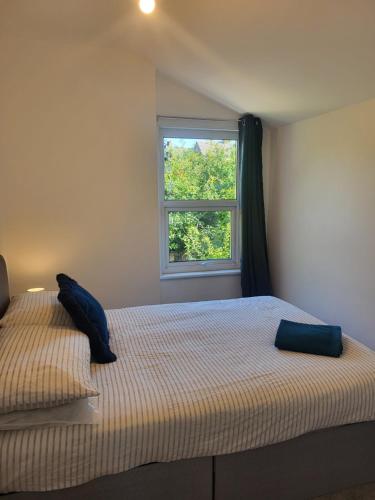 a bedroom with a bed and a window at Seaside 3 Bedroom Home in Ramsgate