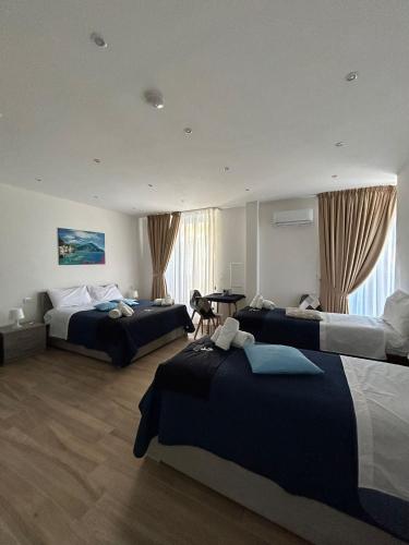 a hotel room with two beds and a table at GIULY SUITES & ROOMS in Naples