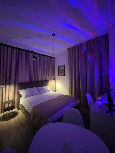 a bedroom with a bed and purple lights at Oriani39 B&B in Bologna