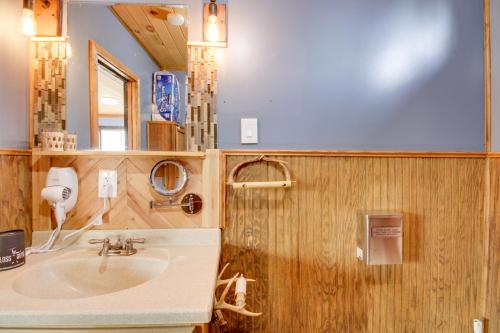 a bathroom with a sink and a mirror at Quaint Ironton Getaway with Fire Pit, Gas Grill! in Ironton