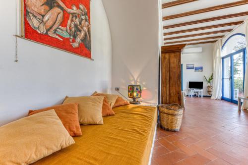 a couch in a room with a painting on the wall at Villa Blu La Cambusa in Castro di Lecce