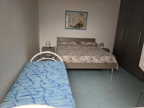 a small bedroom with a bed and a bedskirts at Holiday Apartments Azzurro Salento in Torre Vado