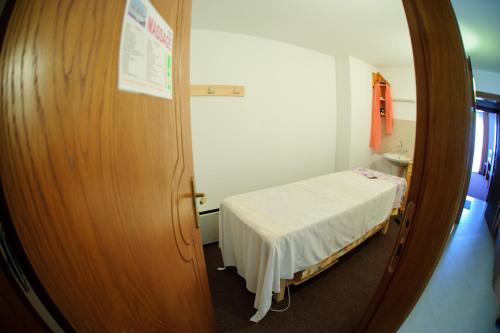 a hospital room with a bed and a mirror at Family Hotel Nadejda in Bansko