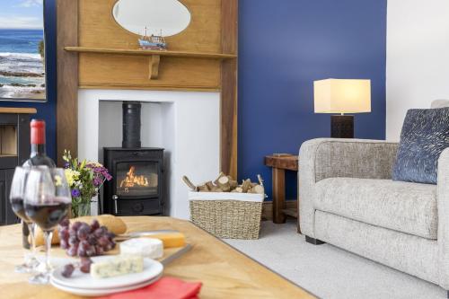 a living room with a couch and a fireplace at Seaway Garden, Beachside Maisonette with Parking in Paignton