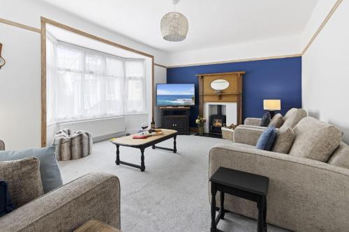 a living room with a couch and a table at Seaway Garden, Beachside Maisonette with Parking in Paignton