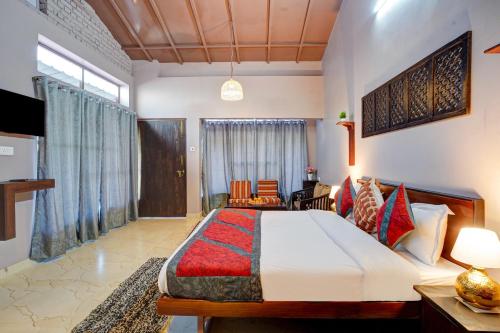 a bedroom with a large bed in a room at Nature's Vibe Stays Mukteshwar - A 4BHK Plum Orchard Villa in Mukteswar