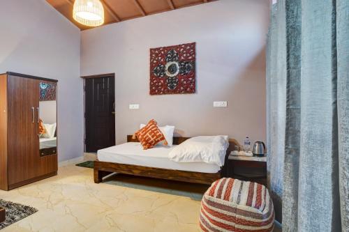a bedroom with a bed and a table at Nature's Vibe Stays Mukteshwar - A 4BHK Plum Orchard Villa in Mukteswar