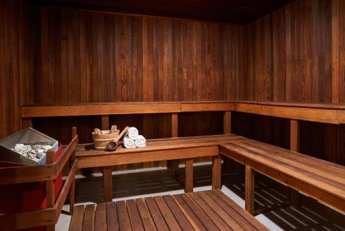 an empty sauna with a wooden bench and a table at Four Seasons Washington DC in Washington