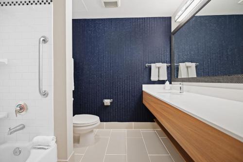 a bathroom with a tub and a toilet and a sink at Fairfield Inn & Suites Fort Lauderdale Airport & Cruise Port in Dania Beach