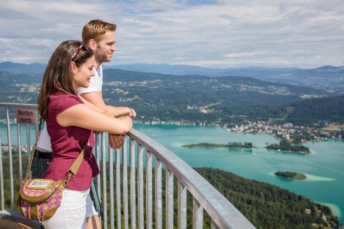 a man and a woman standing on top of a mountain at Hotel Gabriel in Keutschach am See