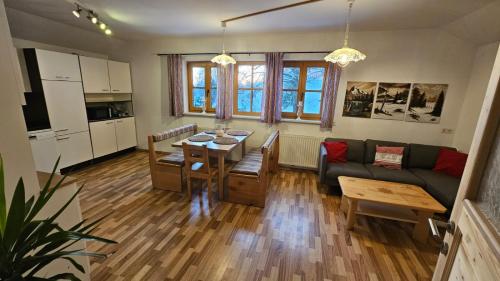 a living room with a table and a couch at Bio-Schafbauernhof-Kölbel in Grimmenstein