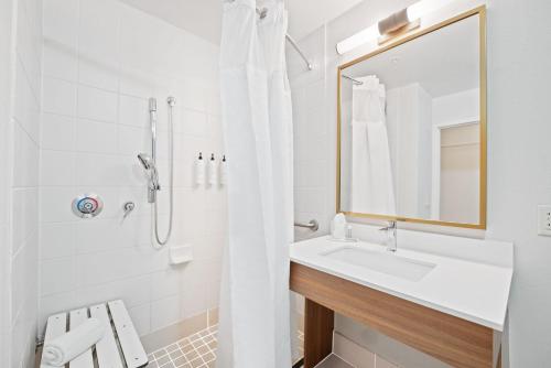 a white bathroom with a sink and a mirror at Fairfield Inn & Suites Fort Lauderdale Airport & Cruise Port in Dania Beach