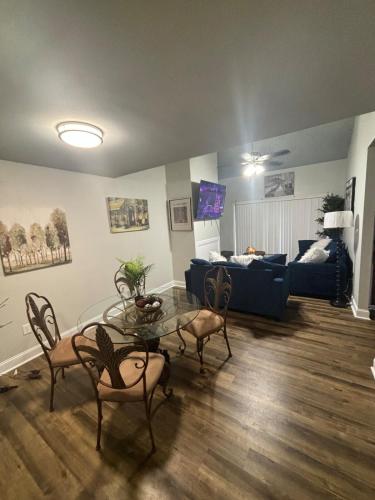 a living room with a table and a couch at Perkins Cove in Baton Rouge