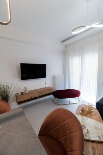 a living room with a flat screen tv on a wall at Minimal Trikala Escape in Tríkala