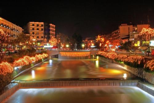 a large water fountain in a city at night at Minimal Trikala Escape in Tríkala