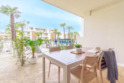 a dining room with a table and chairs and palm trees at Wave Island in Lido di Jesolo