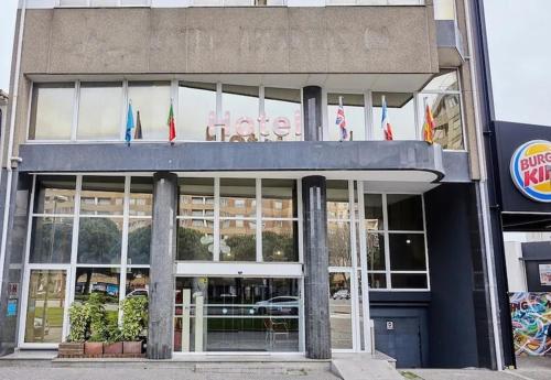 a restaurant with flags on the front of a building at Hotel Amadeos - Matosinhos - Porto in Matosinhos