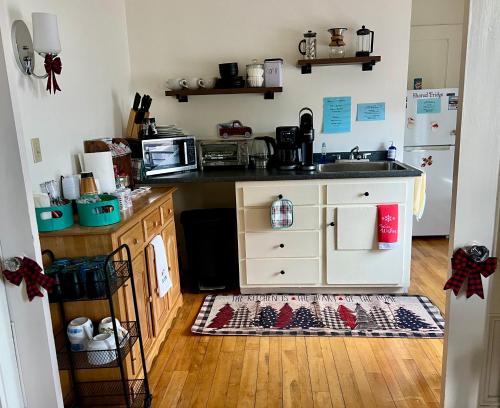 a kitchen with a sink and a counter top at Allegory Inn in Twin Mountain