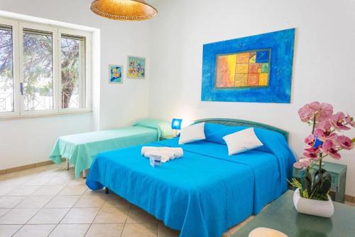 Postel nebo postele na pokoji v ubytování VILLA SABBIA D'ORO Torre Pali