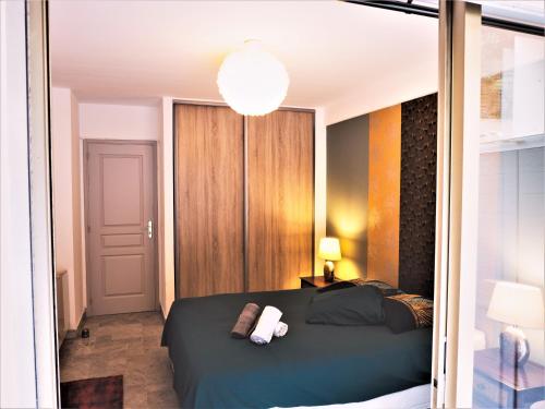 une chambre avec un grand lit et une lampe dans l'établissement Grande et belle chambre d'hôte avec jardin, au Cannet