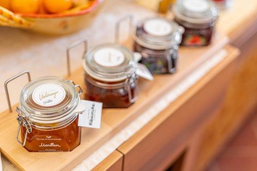 a row of jars of honey on a counter at Hotel&Ristorante Miramonti Palazzo Storico in Rieti