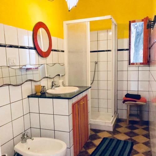 a bathroom with a sink and a toilet and a shower at La Gallina Felice B&B in Meta