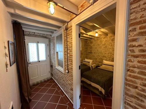 a small room with a bed and a door at Papalina in Ayvalık
