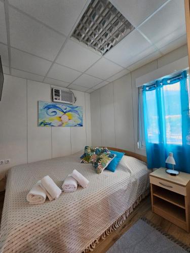 a bedroom with a large bed with towels on it at Kuća s jacuzzijem Mavrinac in Nerezine