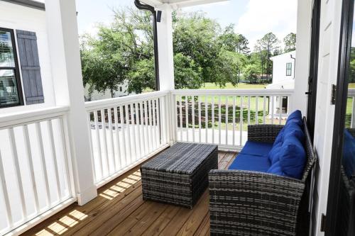a screened porch with a couch and chairs on it at Sleeps 32, Arcade & Game Room, Pool, Golf Cart to Beach in Orange Beach