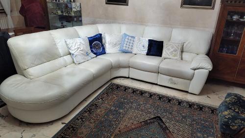 a white couch with pillows on it in a living room at Casa Natale in Prato Sesia
