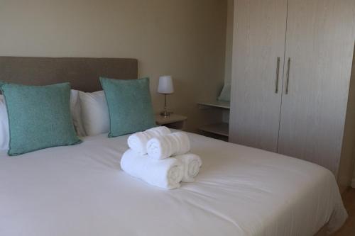 a pile of towels sitting on top of a bed at Tygerviews on Uys in Tygerberg Hills