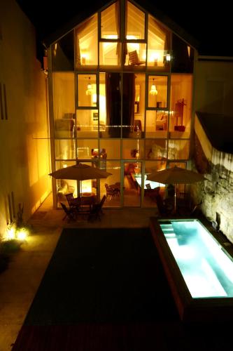 a large building with a pool and a table and chairs at Ocean Porto - Beach House in Matosinhos